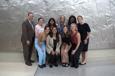 Drs. David Haas and Nicole Scott stand with all 10 PGY3 research presenters