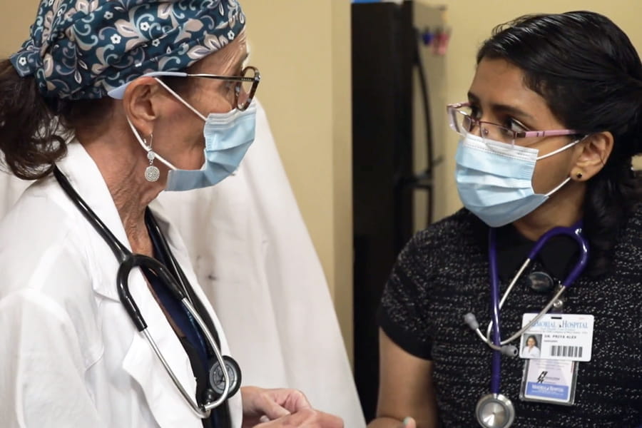 a resident and faculty member collaborate in the clinic