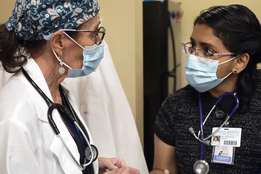 physician and resident conferring on a clinical case