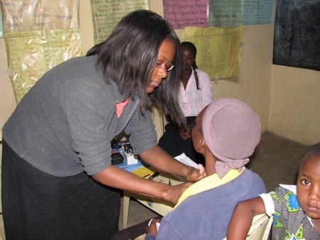 Doshandra Nelson examines a woman during a medical mission trip to Haiti