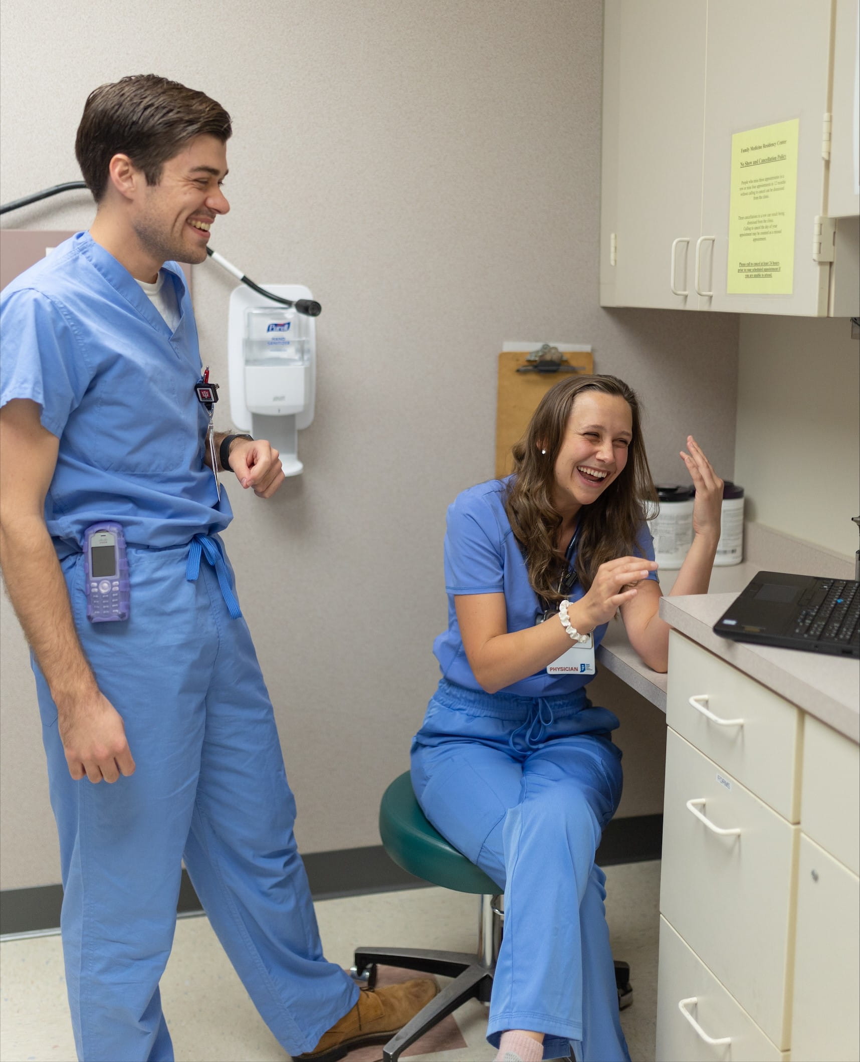 residents laugh together in a work room