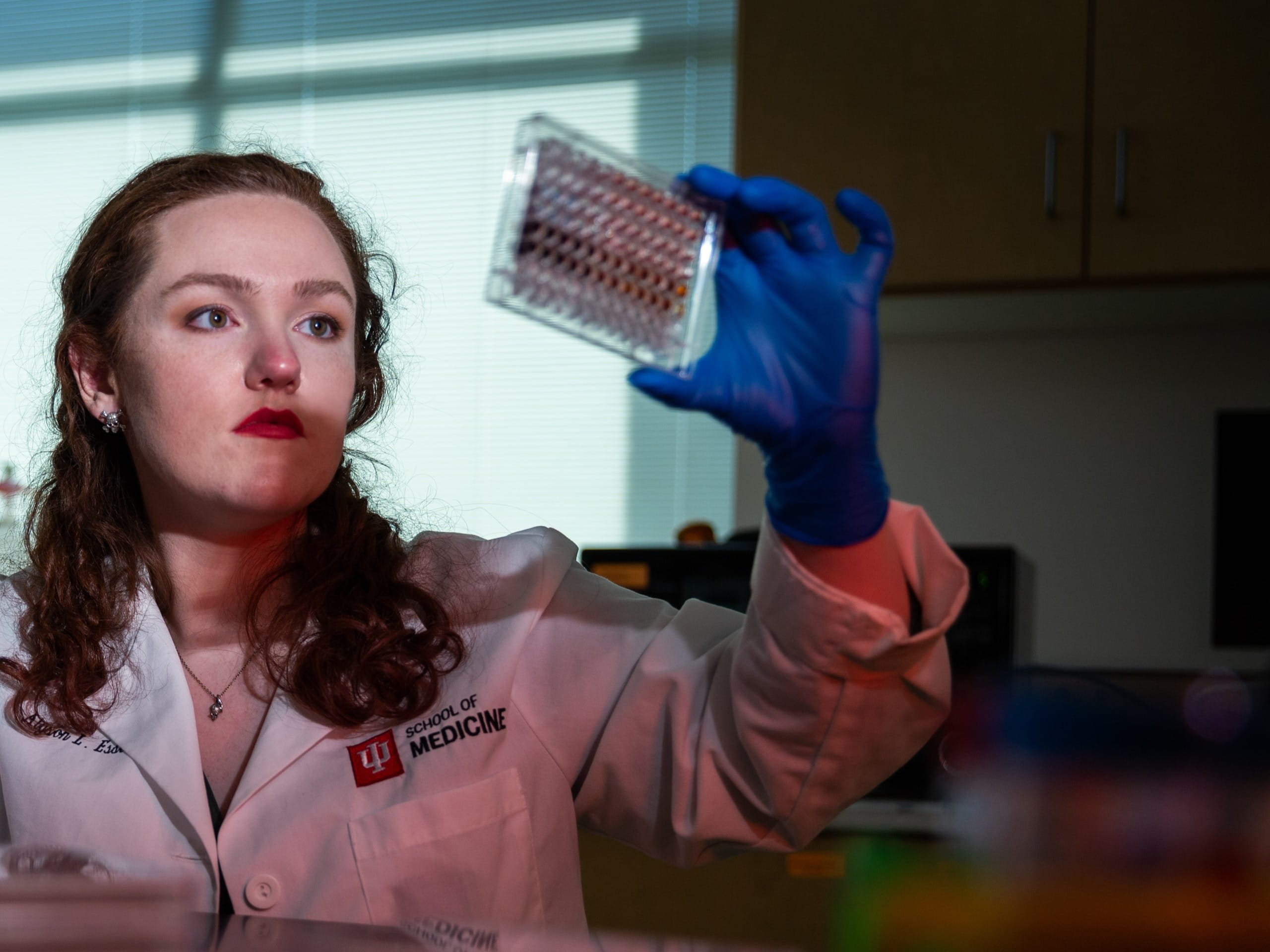 Graduate Student reviews culture in lab