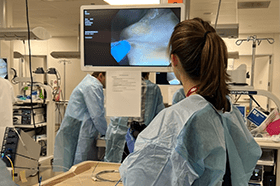 Photo of Elizabeth Williams at a conference using an scope.
