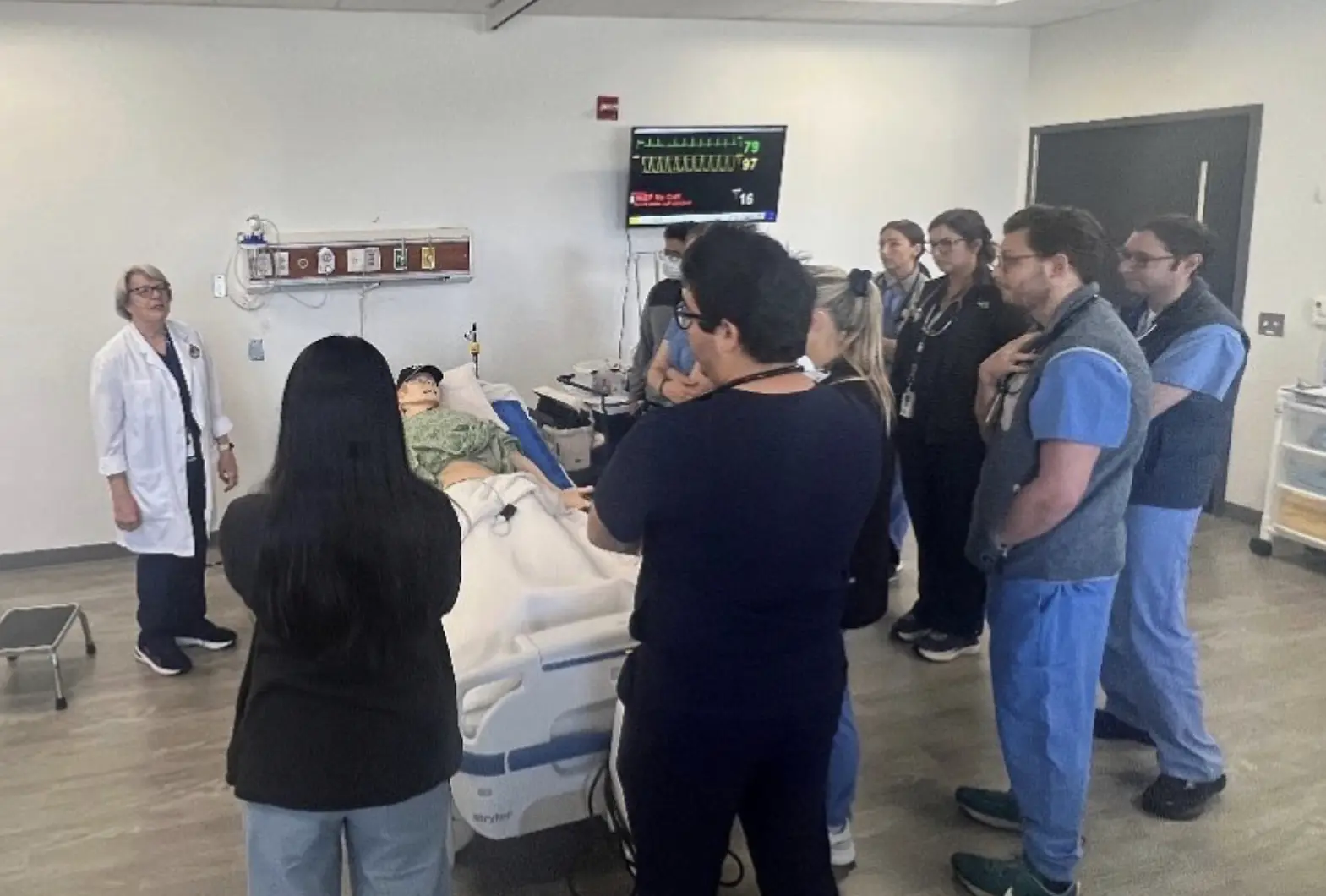 Residents being instructed on bedside practices.