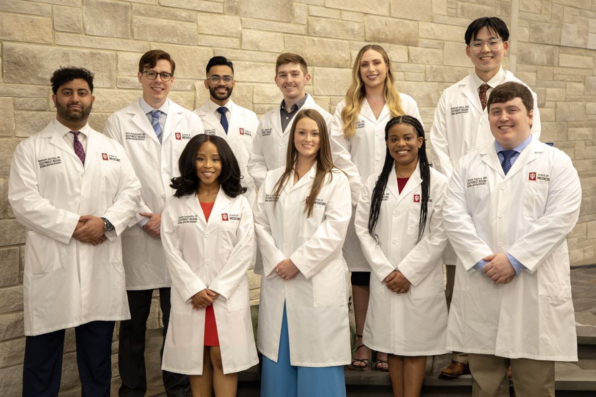 ten residents in white coats