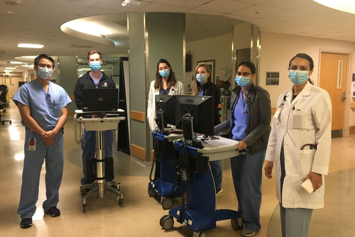 fellows prepare for rounds in the hallway of a hospital