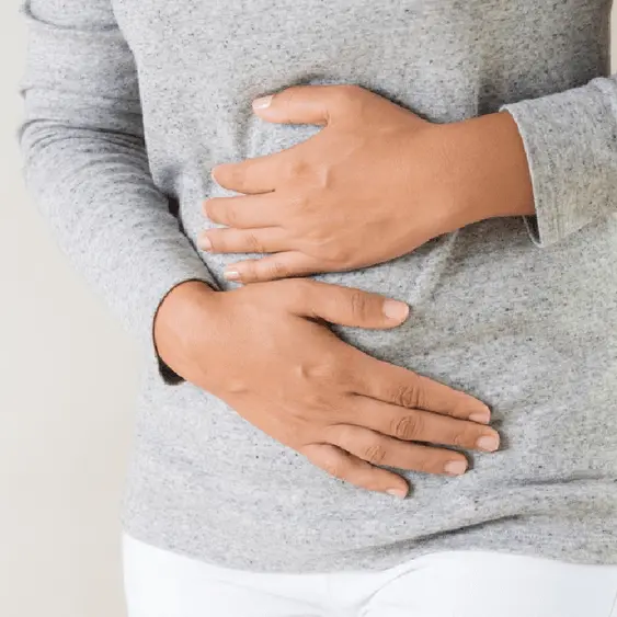 Photo of a person holding their stomach, related to irritable bowel syndrome