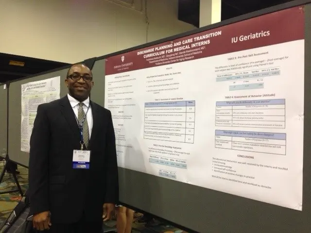 A fellow presents a poster at a conference