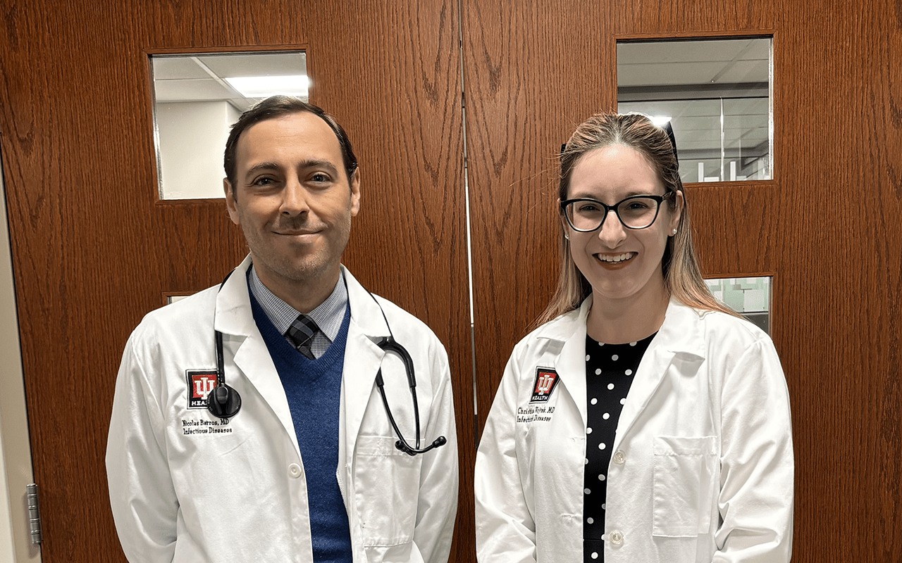 Dr. Nicolas Barros (Left) and Dr. Christina Vojtek (Right) standing in front of a set of doors.