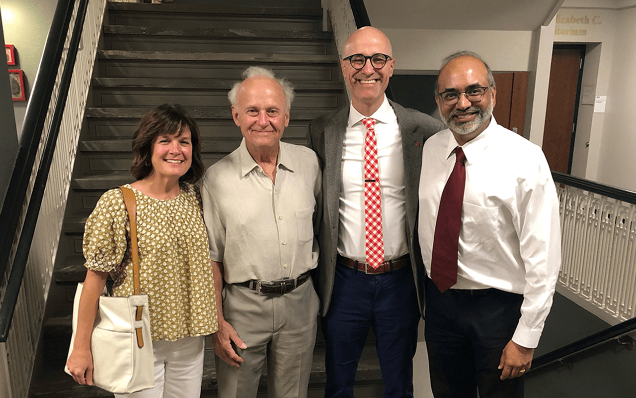 Dr. Heather Largura (Far Left), Dr. Joseph Wheat (Middle Left), Dr. David Aronoff (Middle Right), and Dr. Samir K. Gupta (Far Right) standing on the third floor of Emerson hall in front of the upstairs staircase.