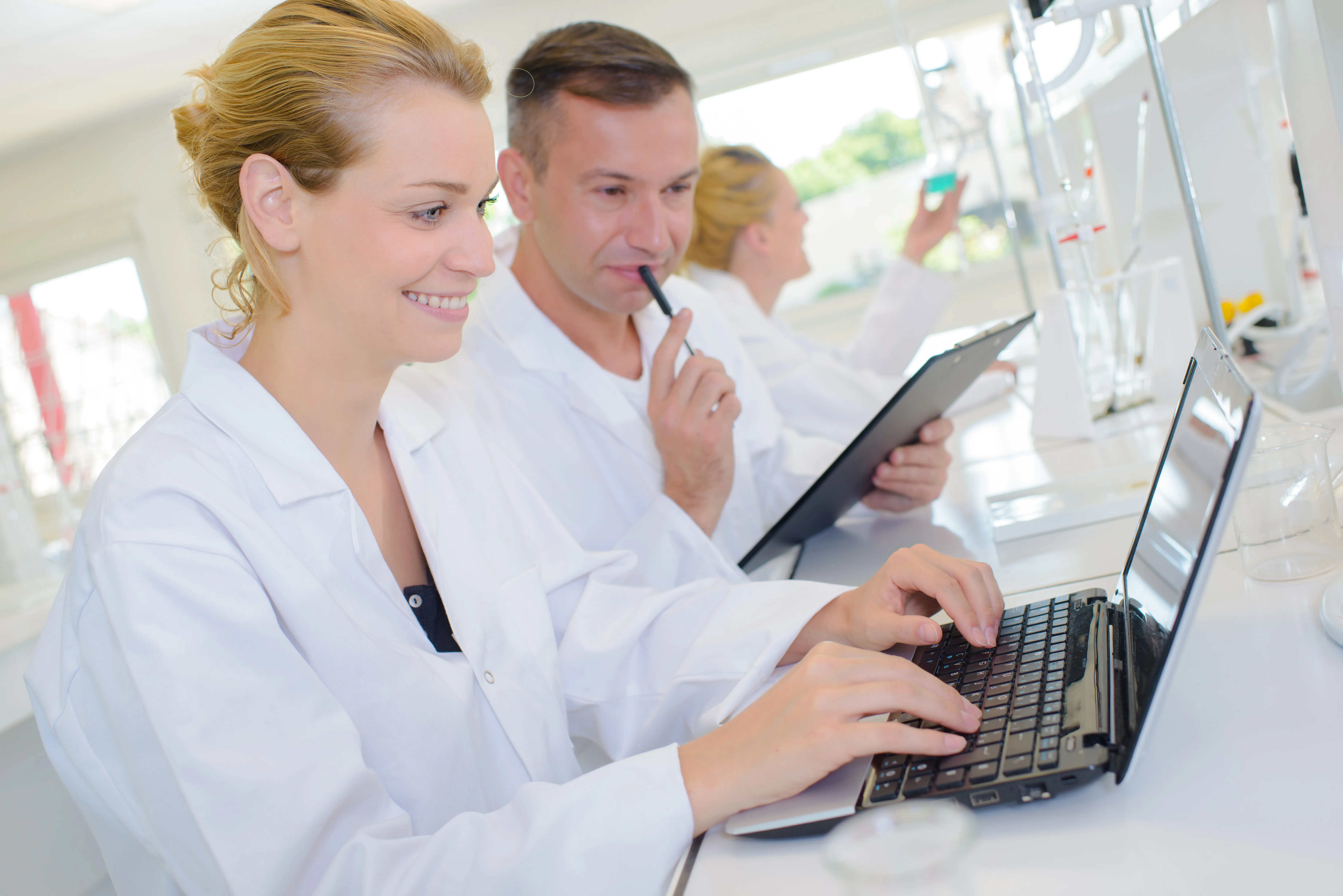 Clinicians discuss results at a computer