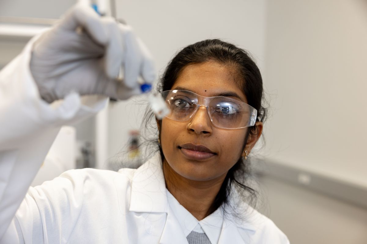 Person in chemistry lab holds a test tube