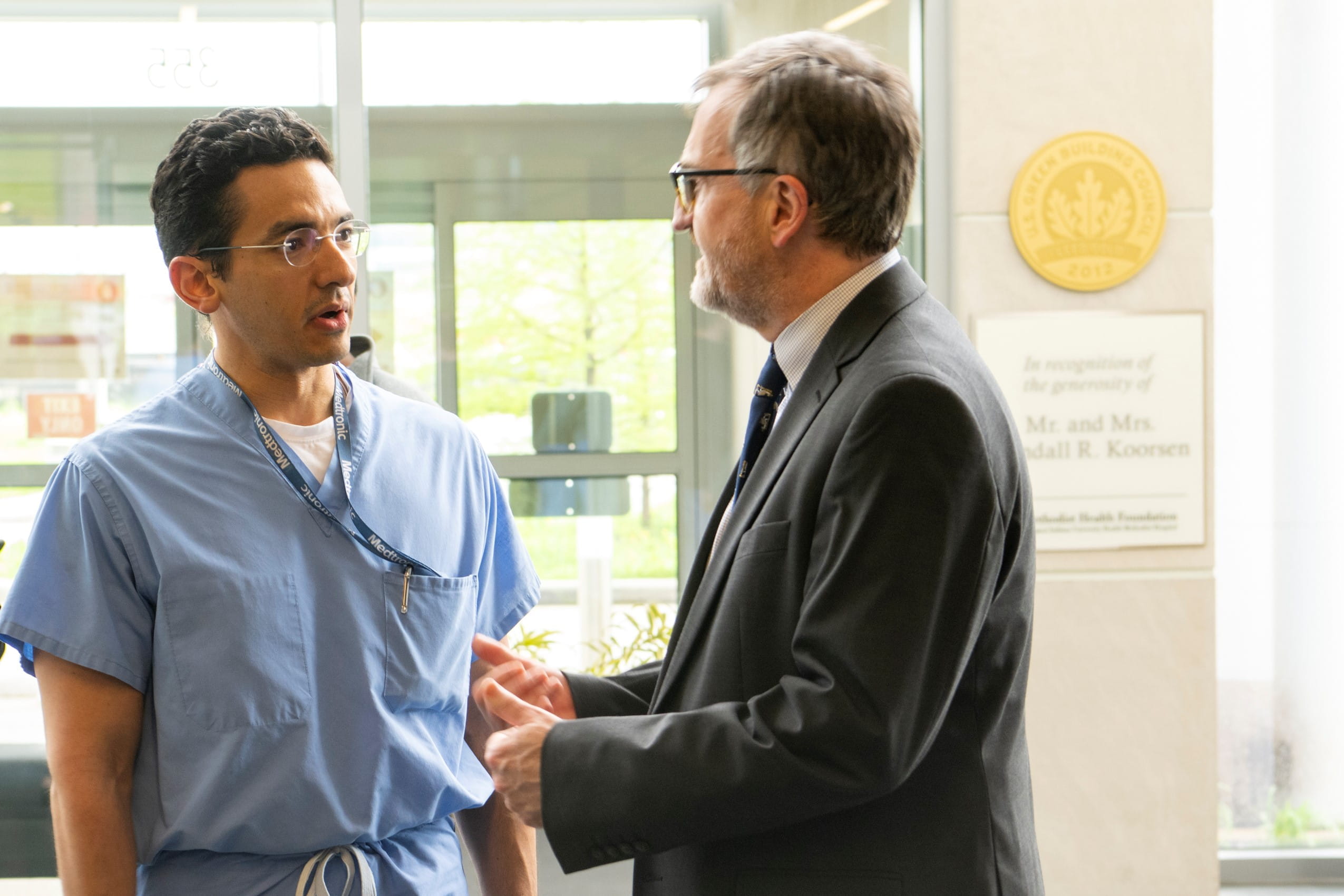 A neurosurgery resident talking with a lectuter
