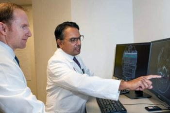 Two Physicians looking at a computer monitor