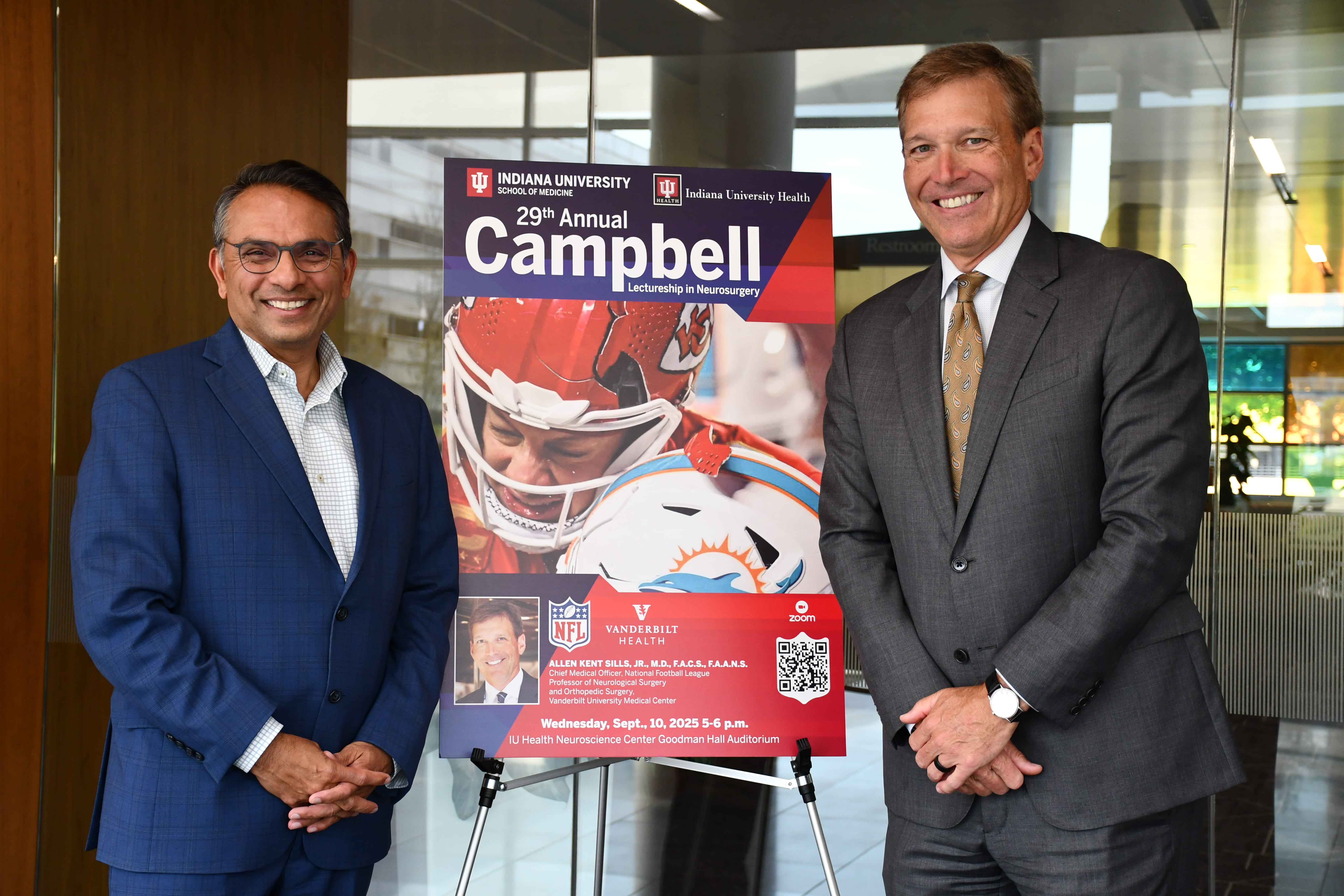 Dr. Mitesh Shah and keynote speaker Dr. Allen Sillis stand next to a poster 