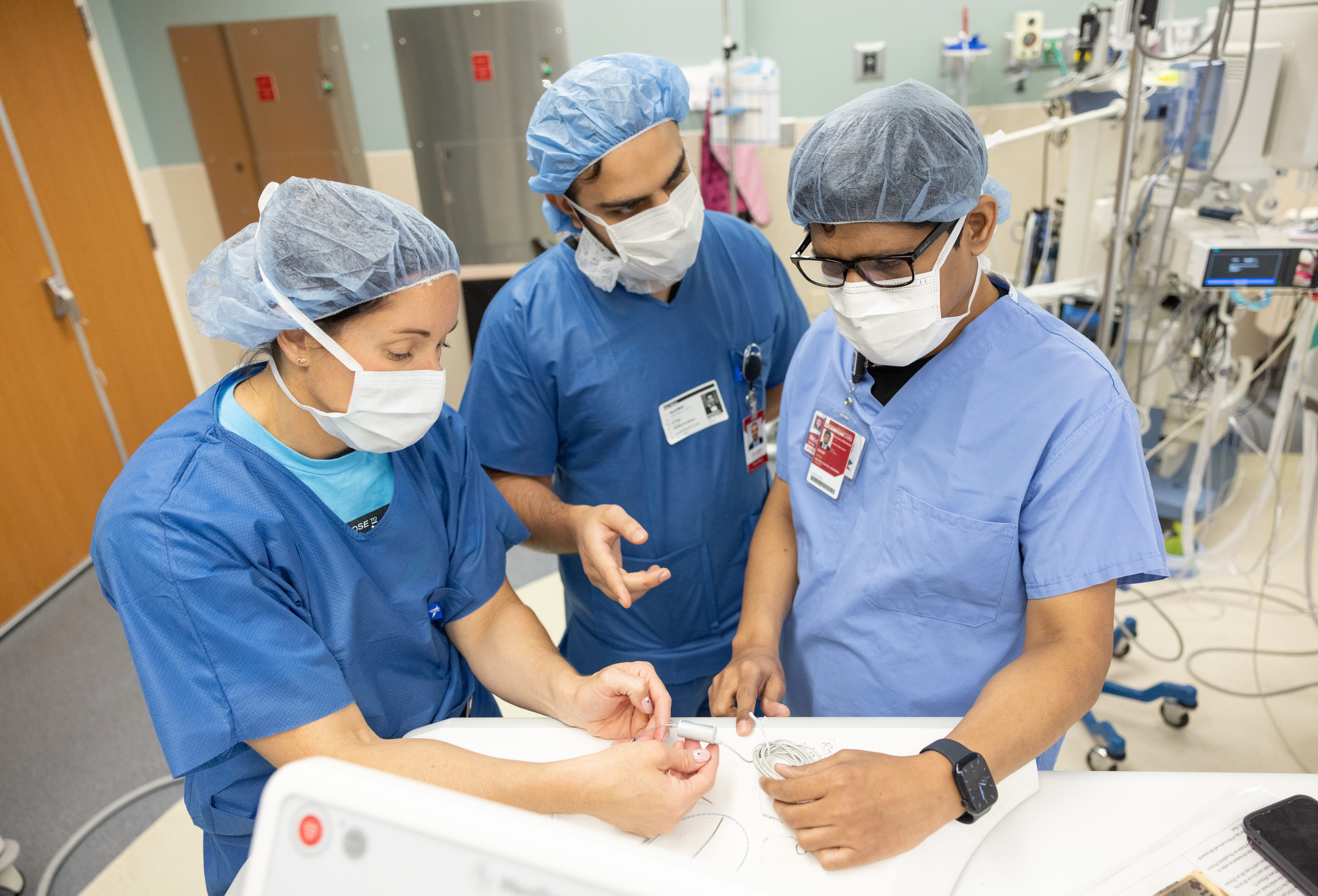 Sohail Noor examining brain waves in the OR