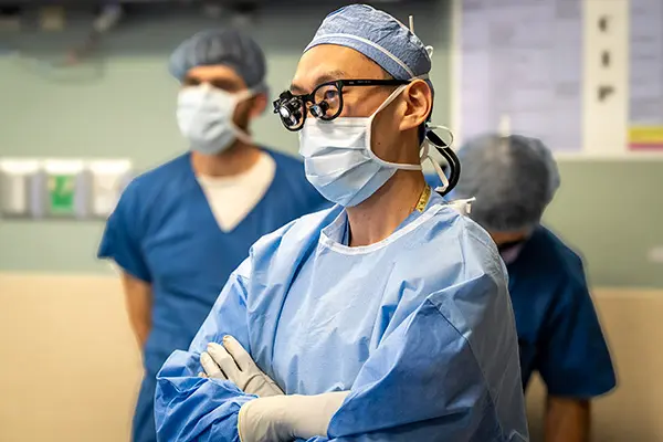 Dr. Frank Yuk performs a spinal operation in the OR