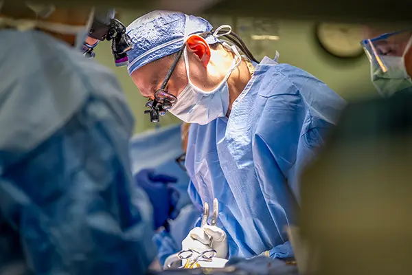 Dr. Frank Yuk performs a spinal operation in the OR