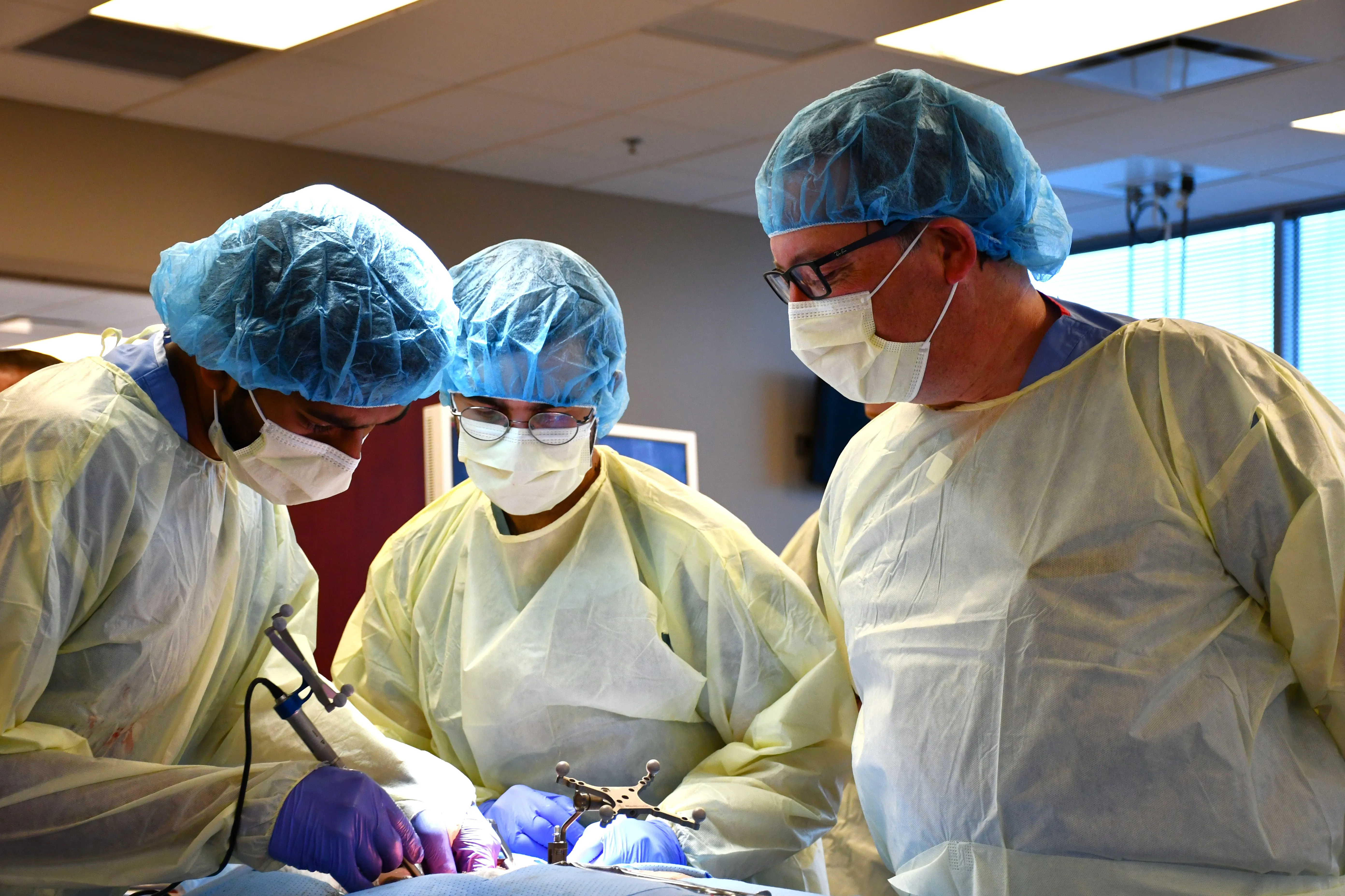 Dr. James Miller works with residents in a training lab. 