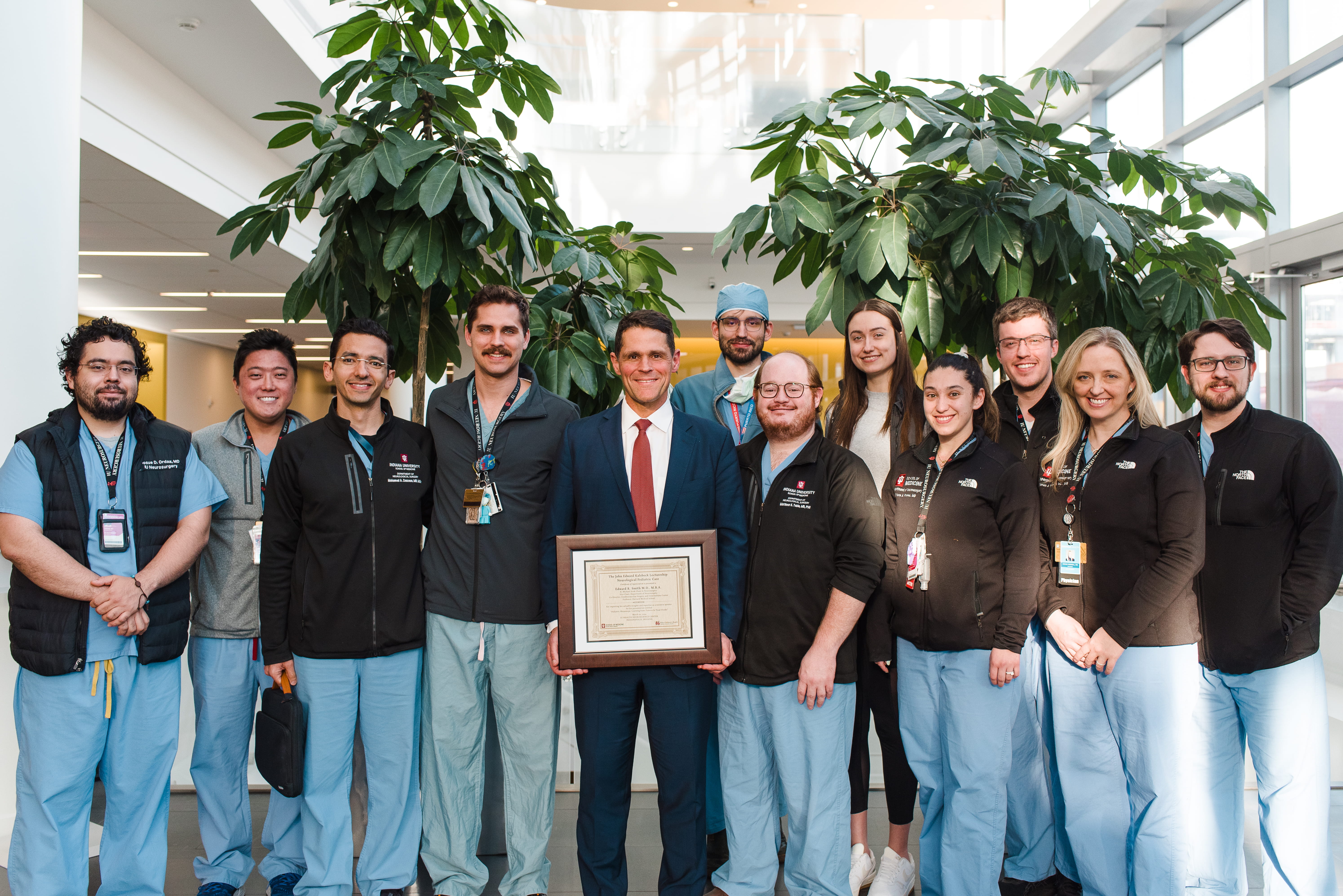 Neurosurgery residents with a guest speaker after a lecture