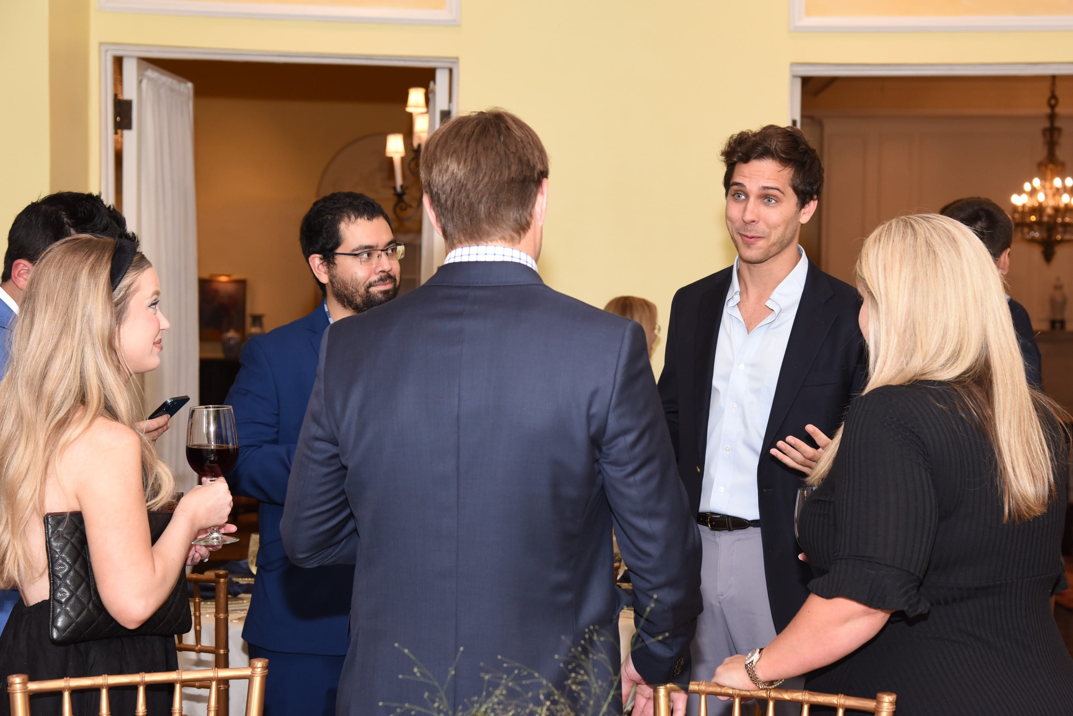 a group of people talk at a reception