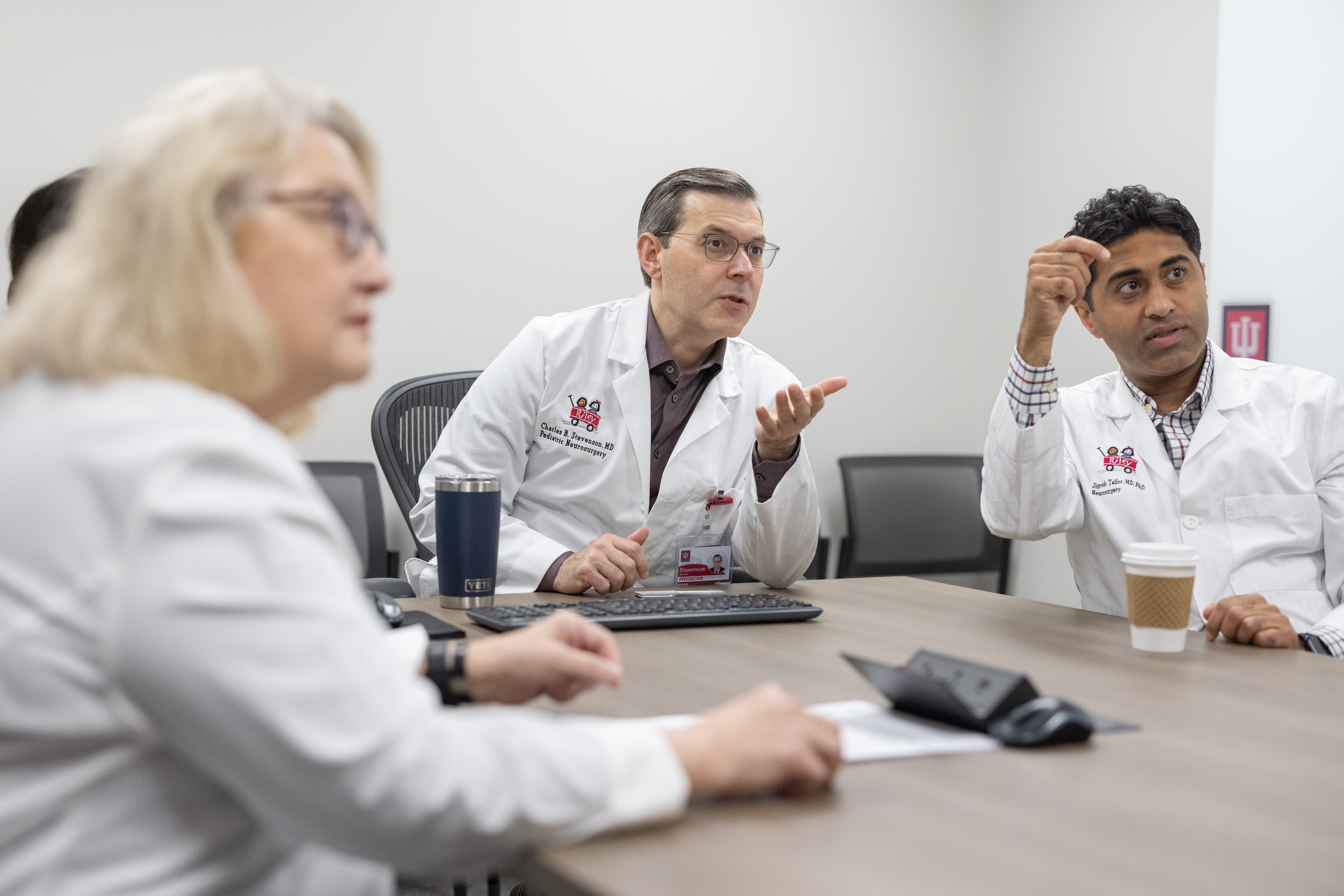 Dr. Stevenson in a meeting with other neurosurgeons 