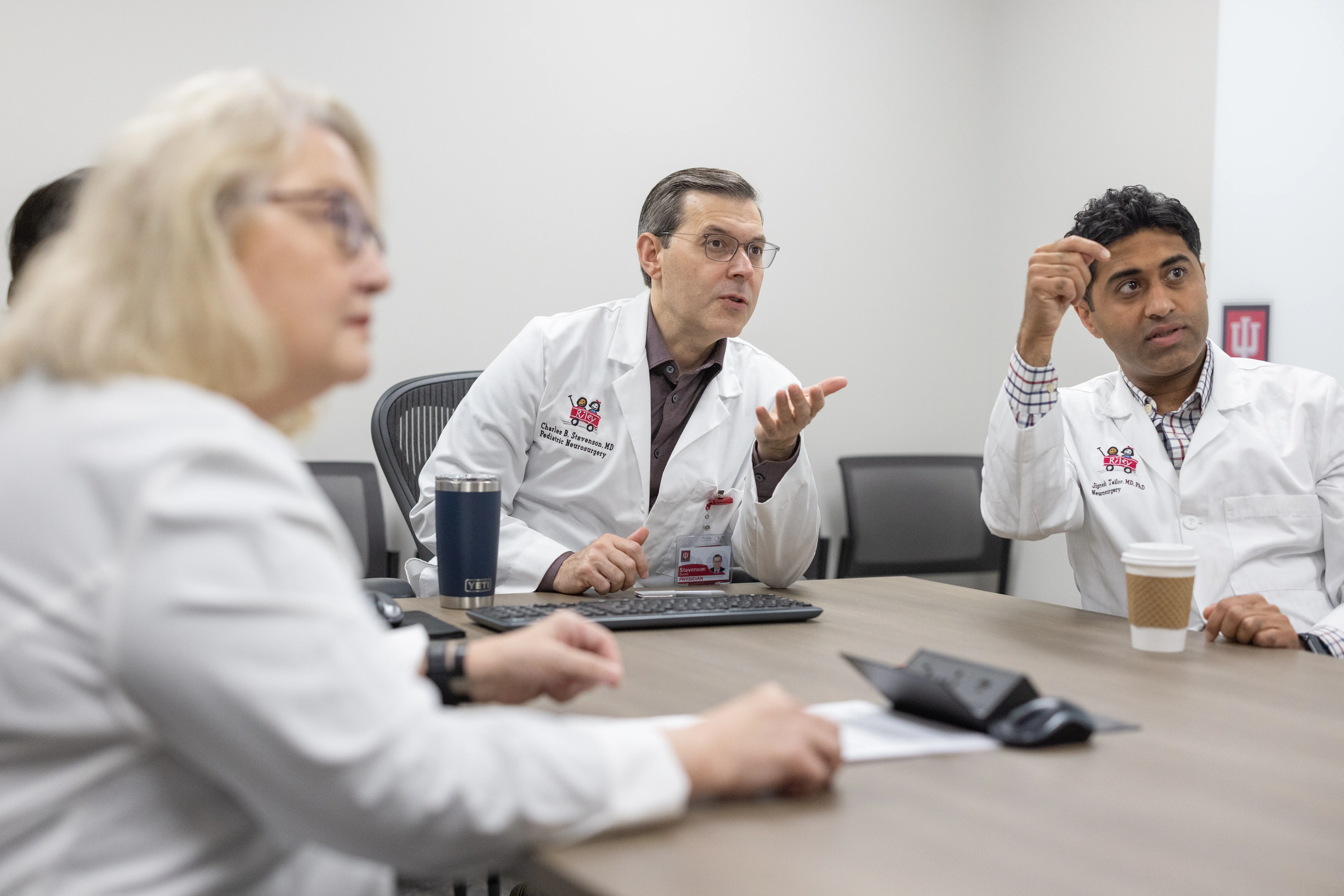 Dr. Stevenson in a meeting with other neurosurgeons 