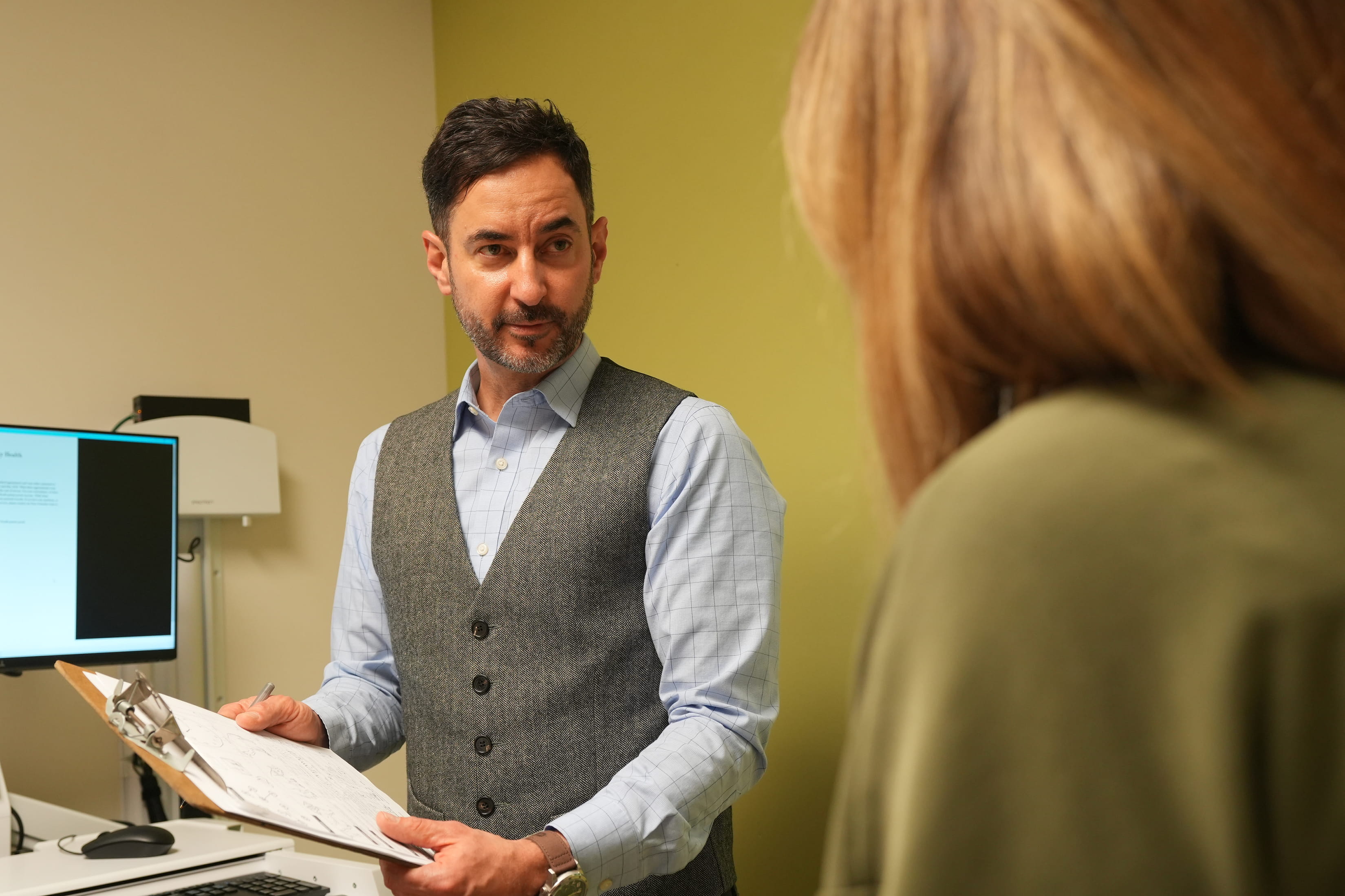 a physician meets with a patient in the clinic