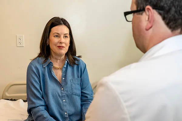 Patient Laura Moriarity meets with Dr. Adam Comer in the clinic.