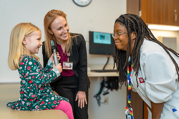 Jerilyn Nova and Stefanie Rodenbeck meet with a pediatric patient at the IU Health Neuroscience Center