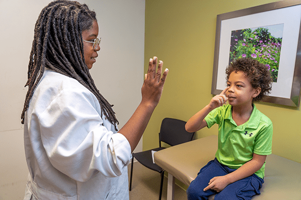 Jerilyn Summay meets with a pediatric patient at the IU Health Neuroscience Center 