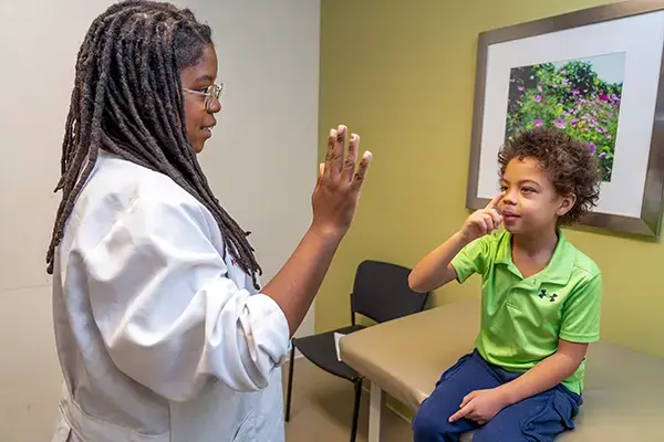 Jerilyn Summay meets with a pediatric patient at the IU Health Neuroscience Center 