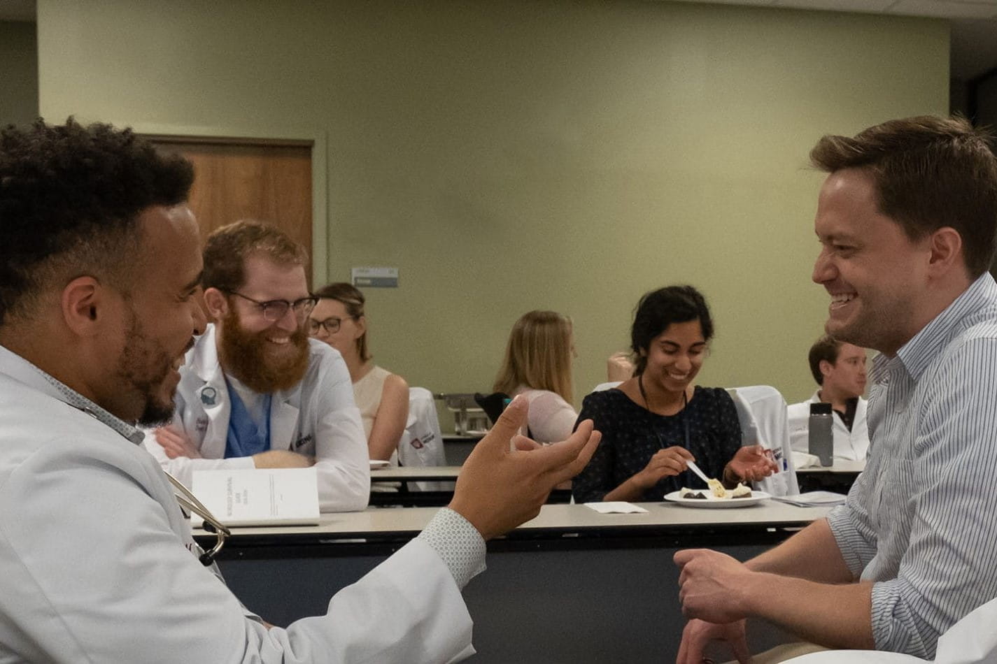 Neurology residents chat over lunch