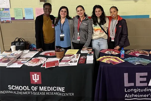 Patricia Garcia with a grou of volunteers at a community event 