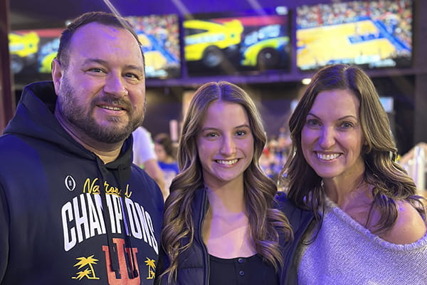 A photo of a husband, wife and their daughter 