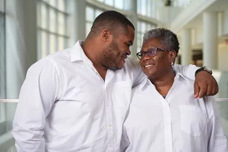 a mother and son embrace