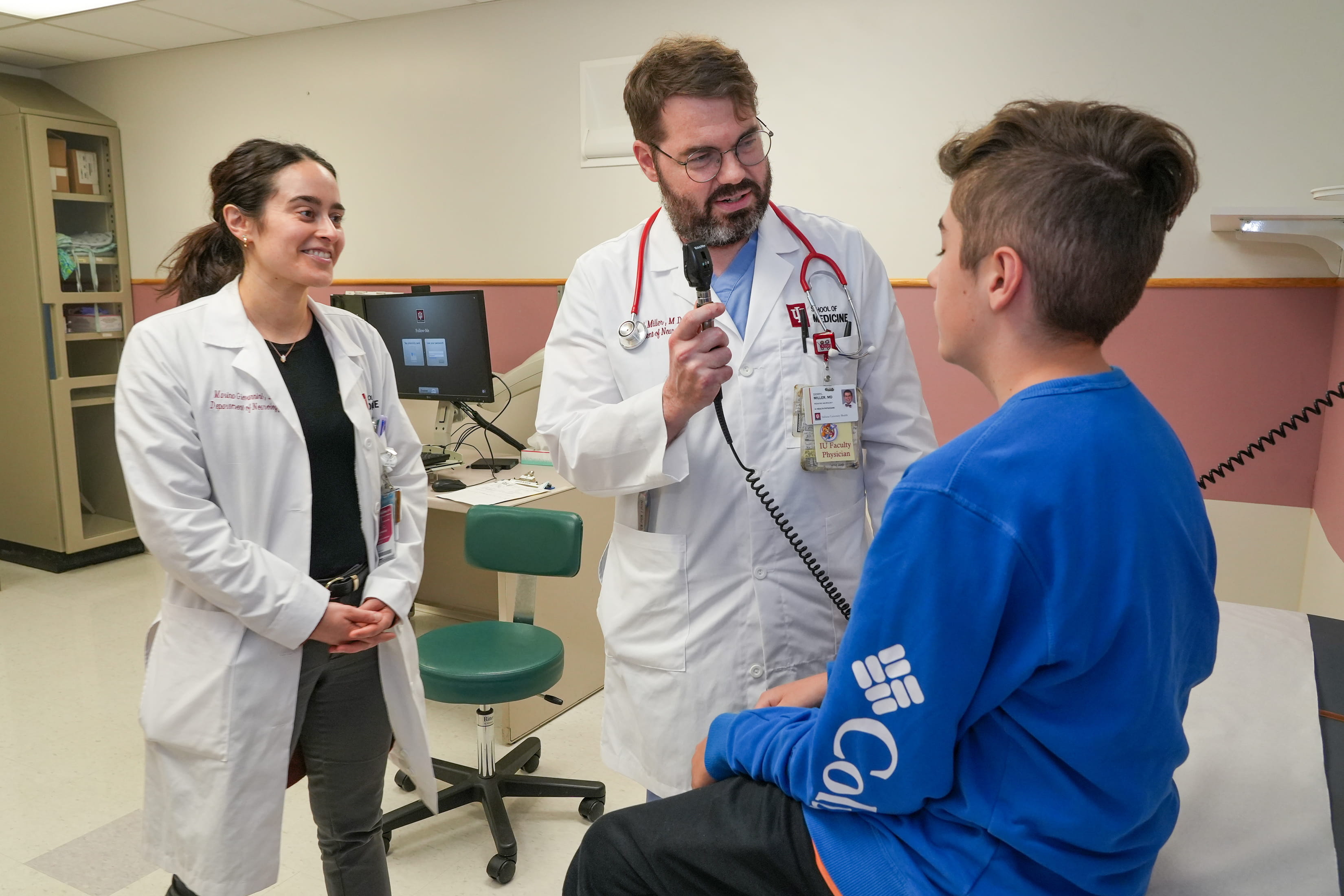 a pediatric neurologist and resident meet with a patient