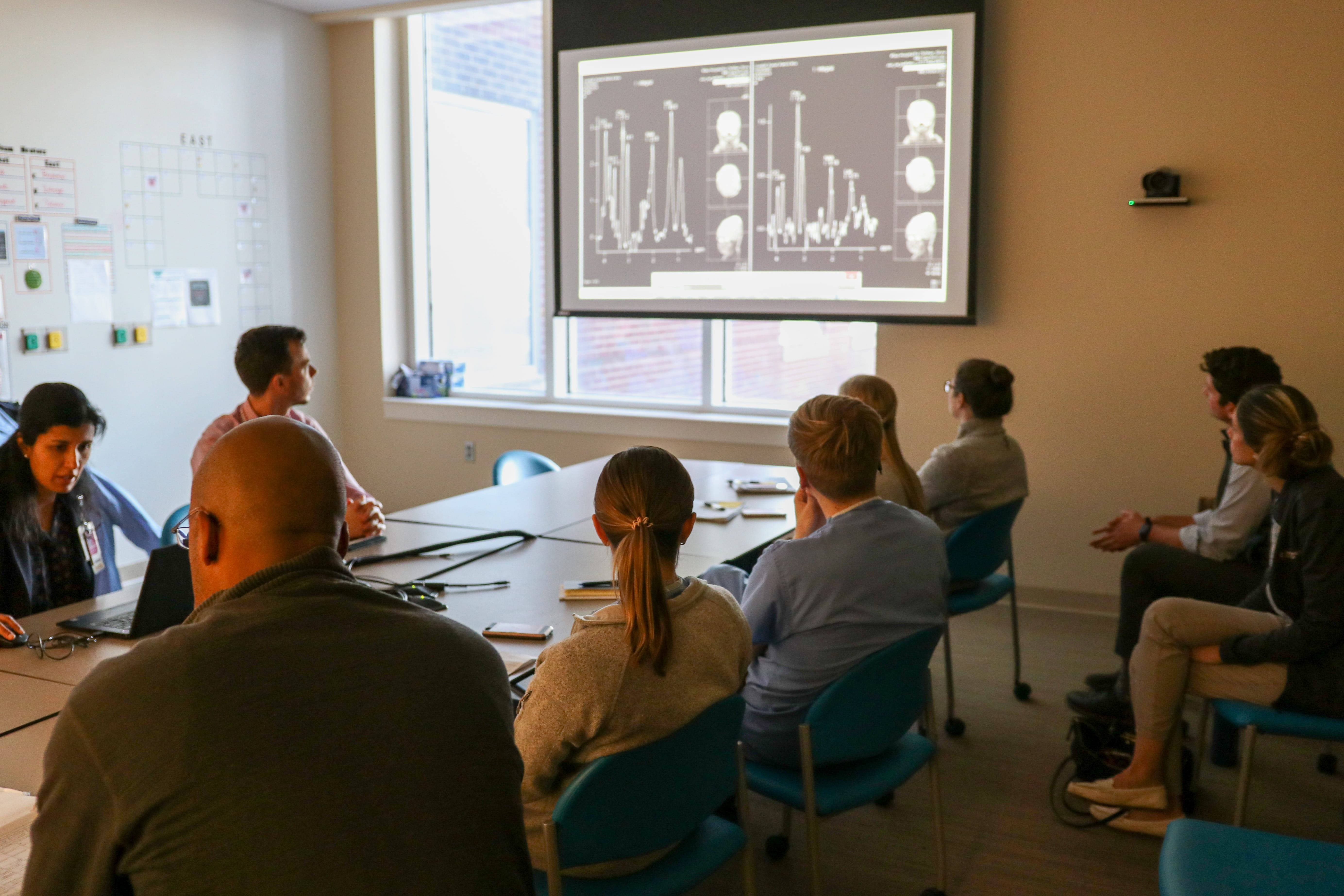 a group of clinicians meet for a Neuro Neonatal ICU meeting