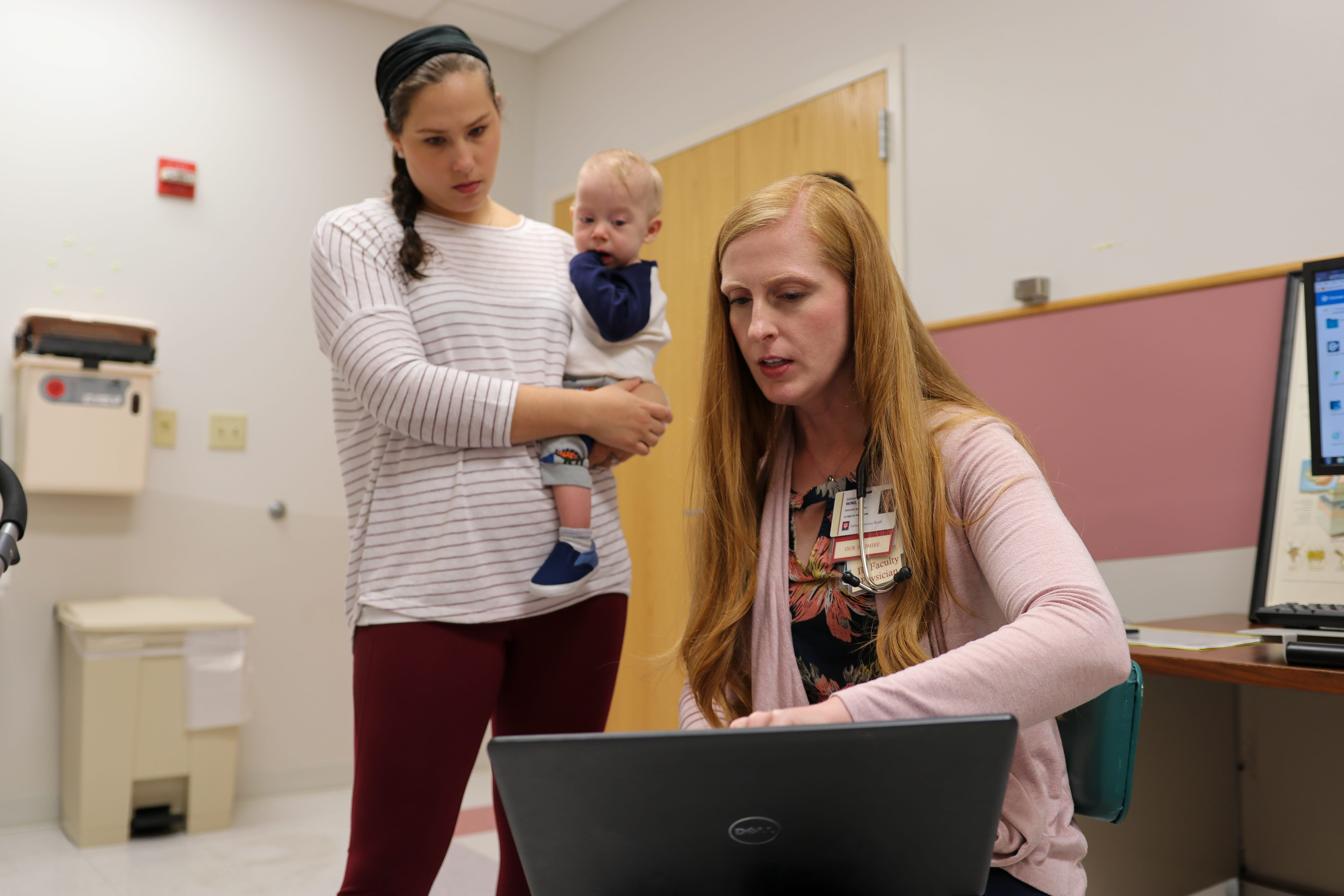a clinician meets with patients in the clinic