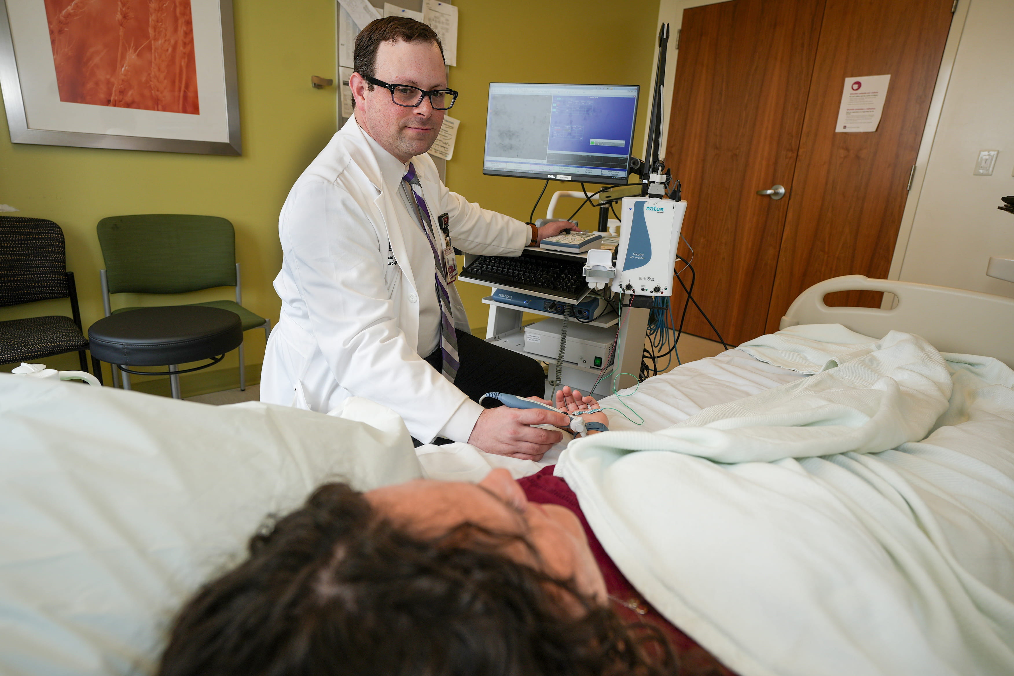 a physician performs an EMG on a patient