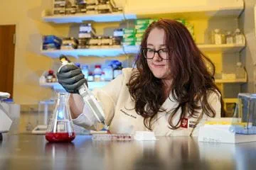 a researcher uses a pipette in the lab