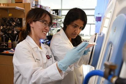 Two female researchers work in a lab at the Glick Eye Institute.