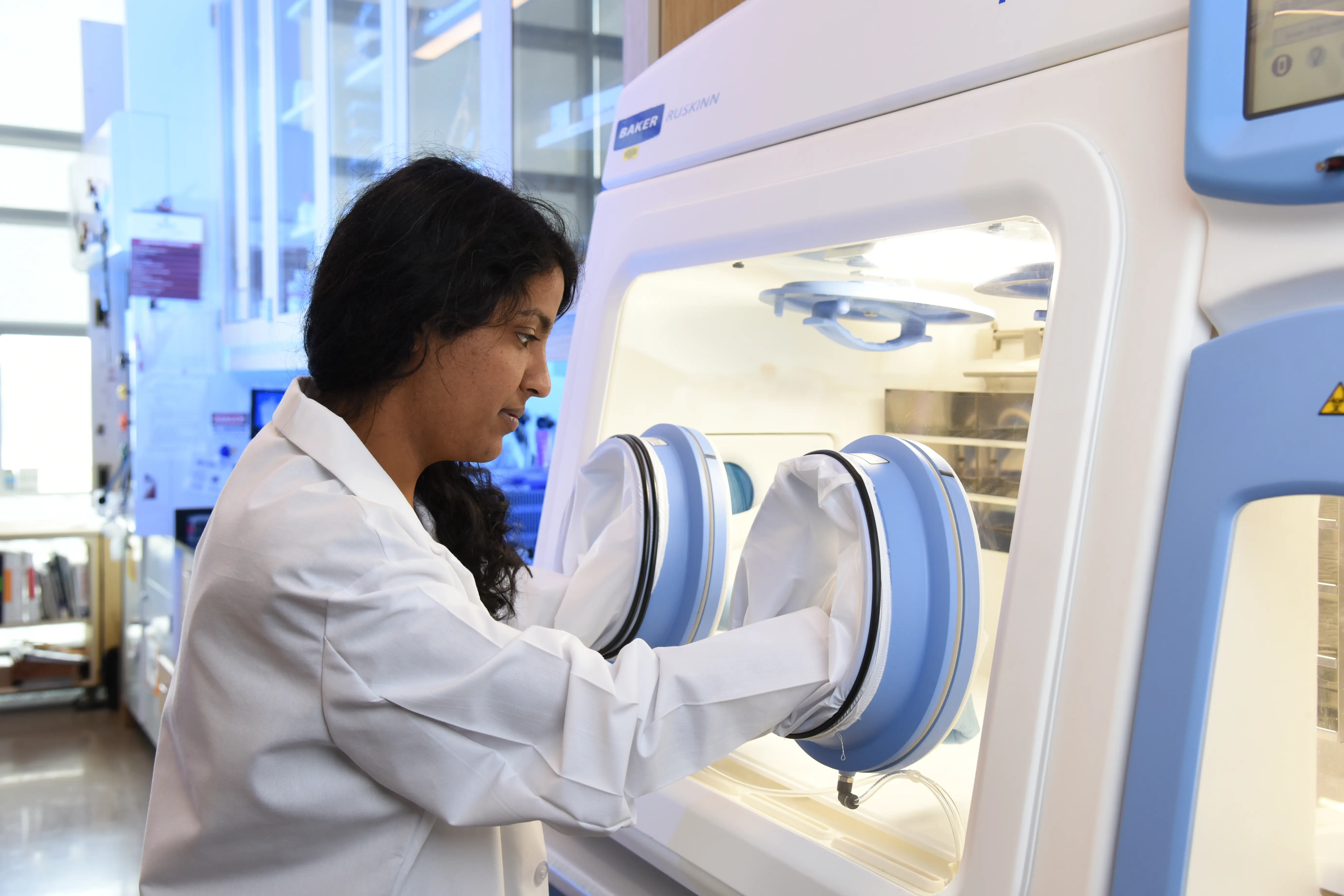 Researchers in the Glick Eye Institute transfer materials into a glass tube.