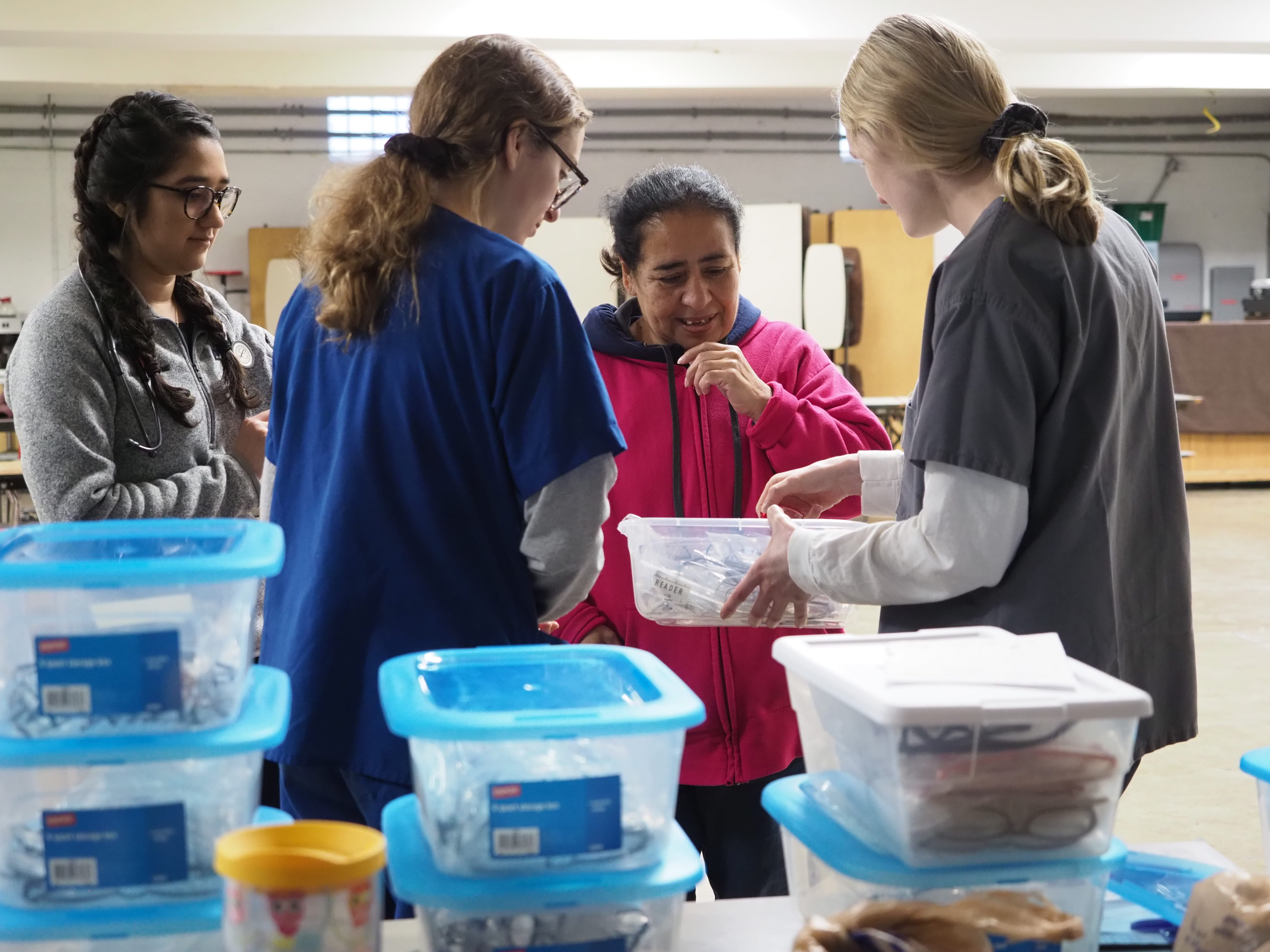 Members of the Ophthalmology Student Interest Group assist a patient at the IU School of Medicine Student Outreach Clinic.