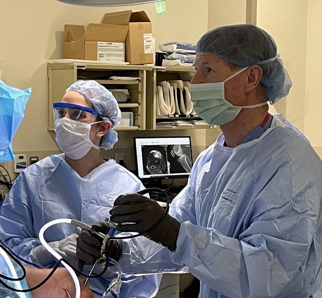 Dan Wurtz, MD, works in surgery with medical student Carly Chapman. 