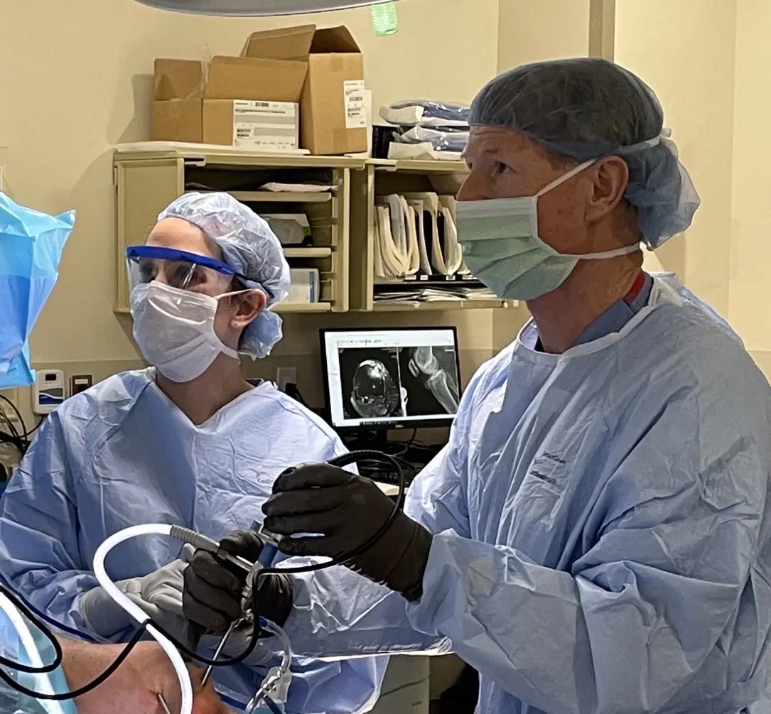 Dan Wurtz, MD, works in surgery with medical student Carly Chapman. 