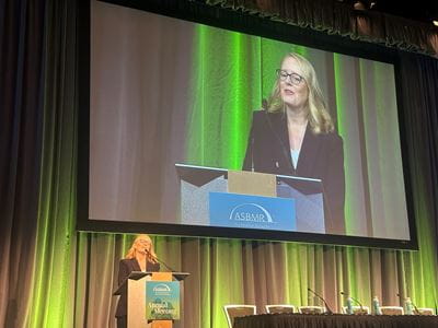 Melissa Kacena speaks at a podium as she accepts the 2023 Stephen M. Krane Award