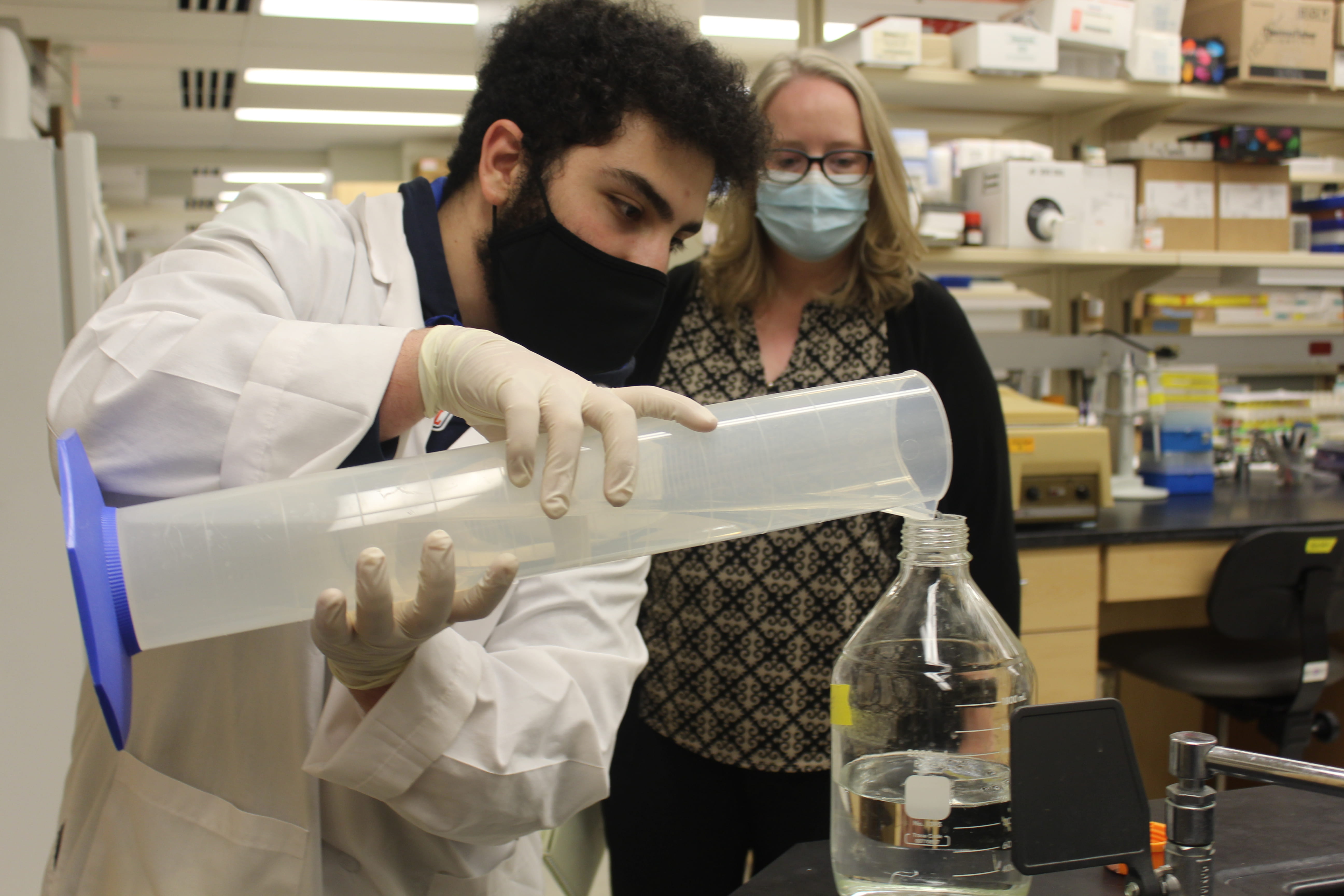 Melissa Kacena works with a student in her lab