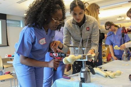 Orthopaedic Surgery faculty member Khusboo Desai, MD, MS, explains a bone repair technique to a student during IU's Perry Initiative outreach event in 2023.