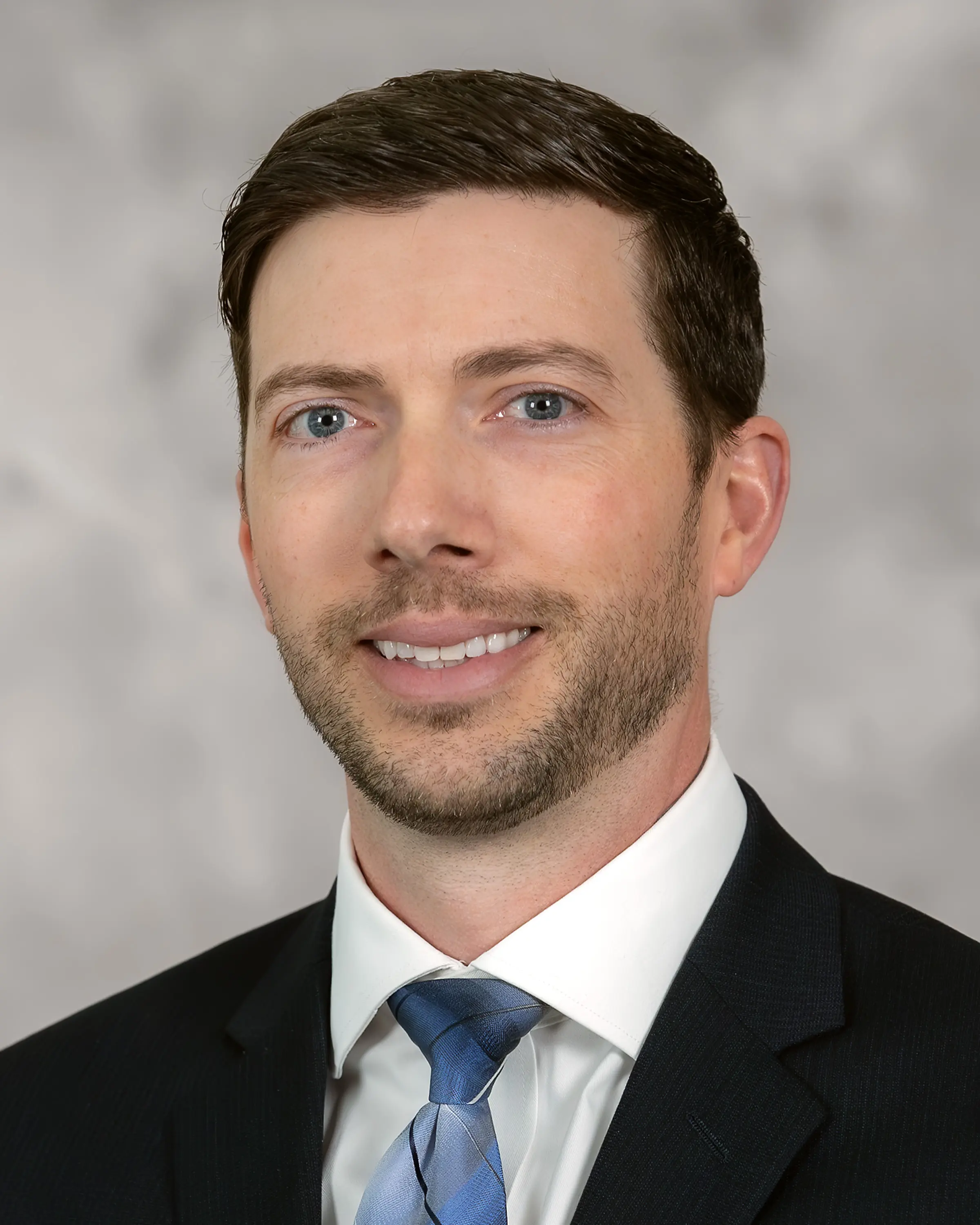 Person in professional attire smiling at camera
